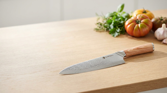 Haruta Japanese Damascus VG10 gyuto chef knife resting on a light oak kitchen worktop